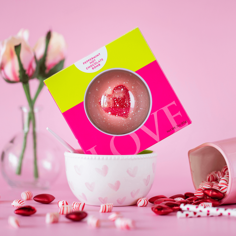 Valentine's day hot chocolate bomb in pink box on pink background. 