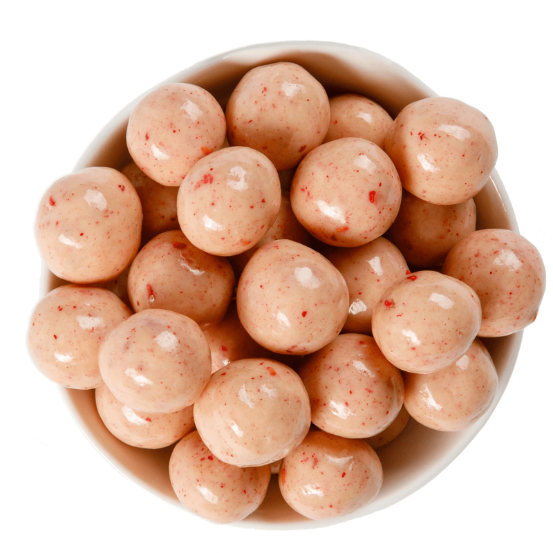 Bowl of white chocolate raspberry malt balls. 