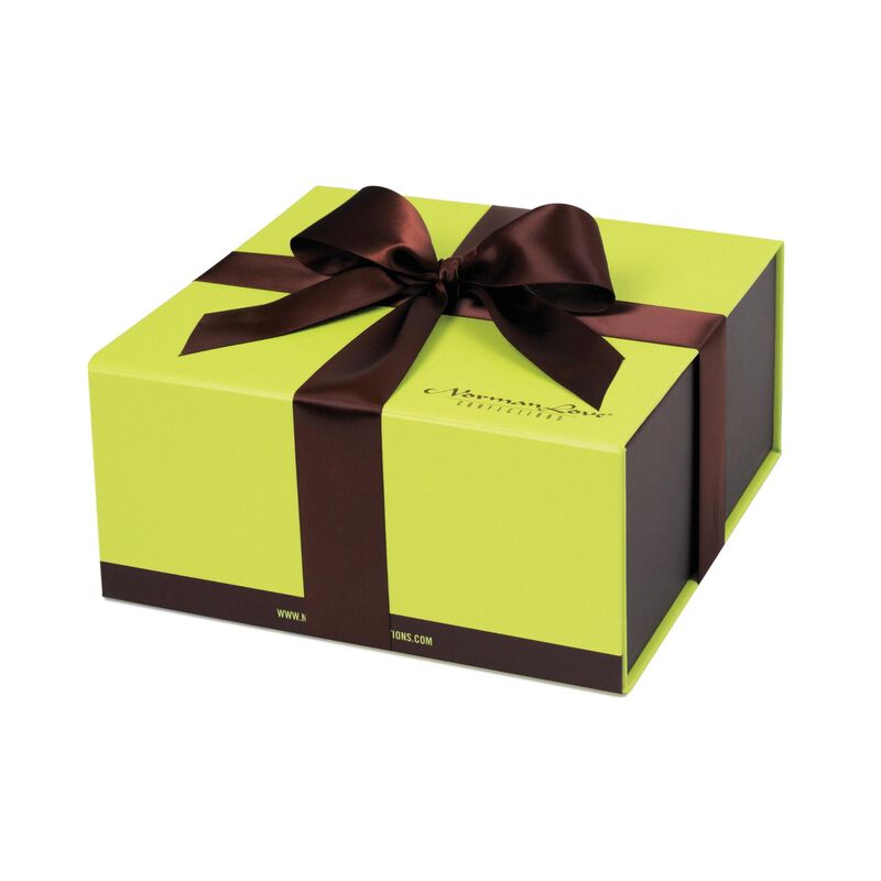 Lime green gift box with brown satin bow on white background. Box has "Norman Love Confections" on bottom right corner of lid