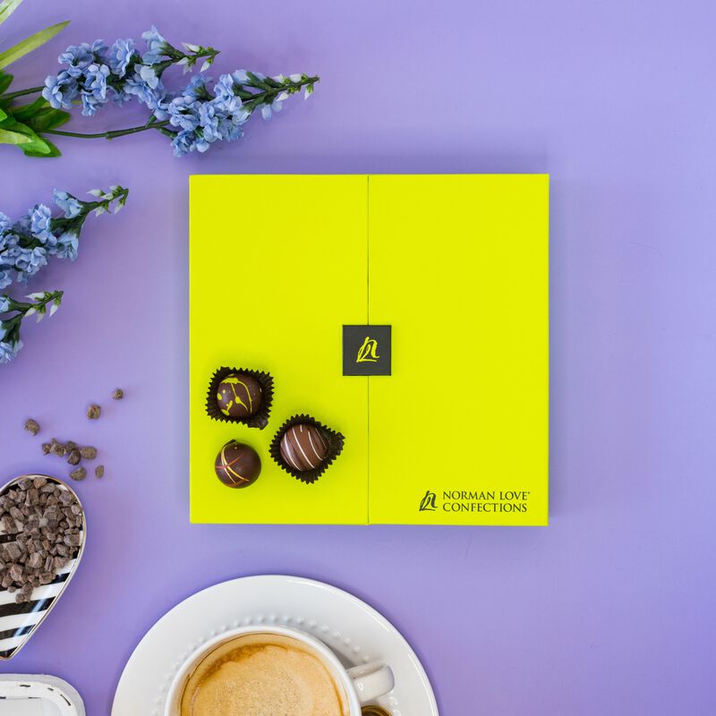 Chocolate truffles gift box on purple background