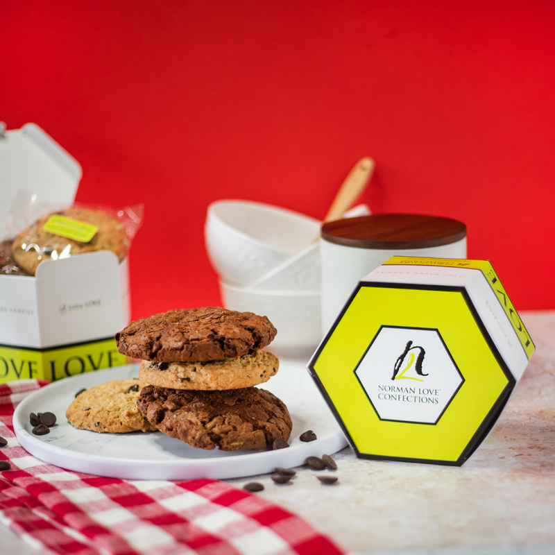 Stack of cookies with yellow hexagon cookie box on red background. 